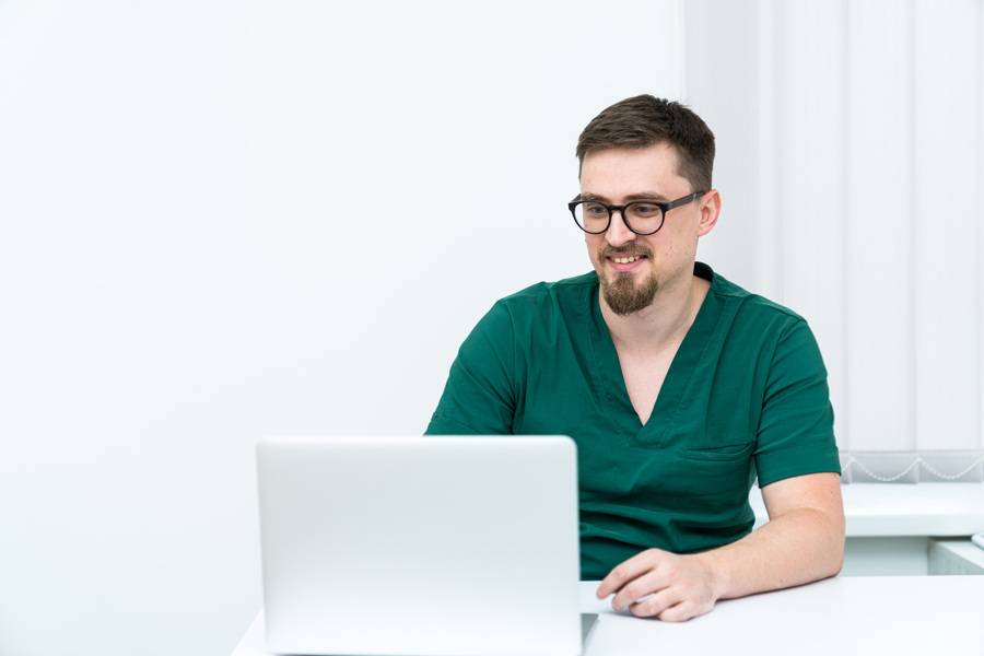 young-clinical-specialist-working-with-computer-handsome-physician-sitting-office.jpg